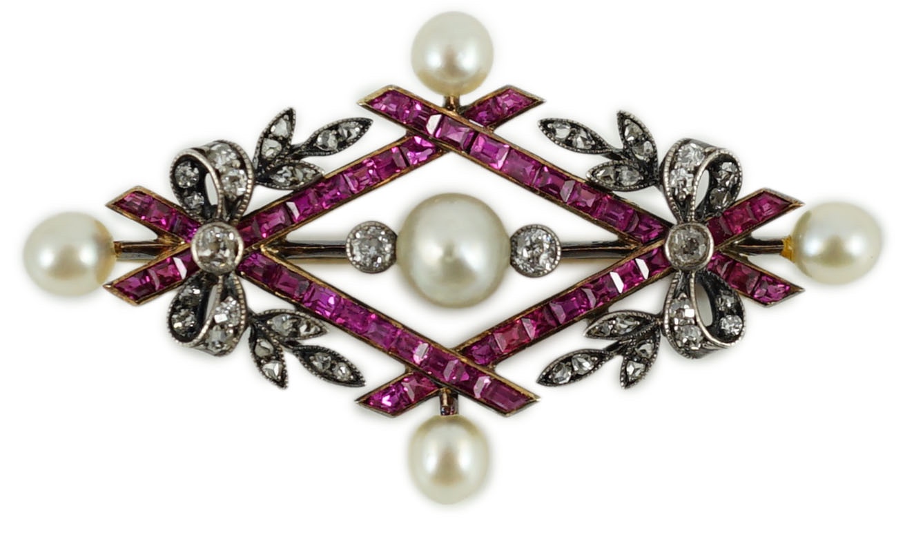 An early 20th century gold and silver, cultured pearl, ruby and diamond cluster set diamond shaped brooch